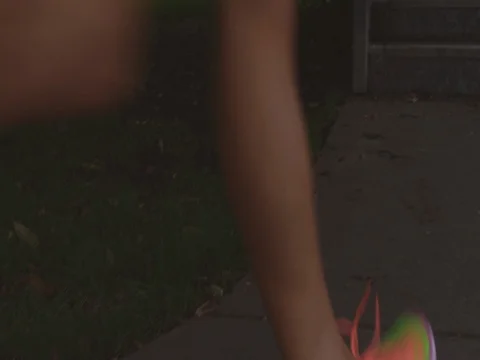 Tilt up slow motion of female athlete moving up steps against sky Stock Footage