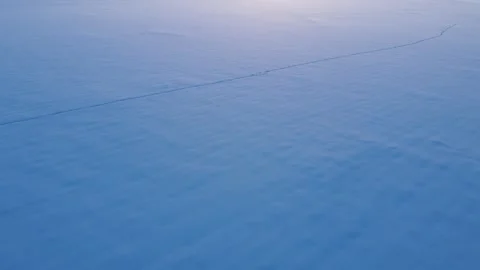 Tilt up snow covered fields at sunset Stock Footage 310571975