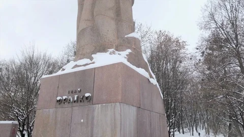 Tilt up of snow covered Monument to Ivan Franko near park in Lviv, Ukraine Stock Footage 101376216