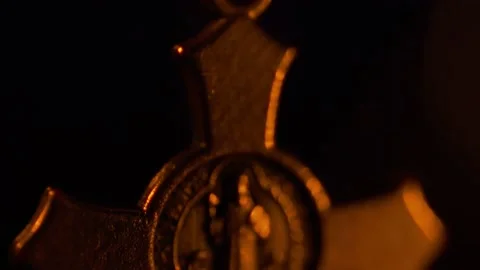 Tilt soft-focus shot of a Saint Benedict rosary in the dark Stock-Footage 163921291