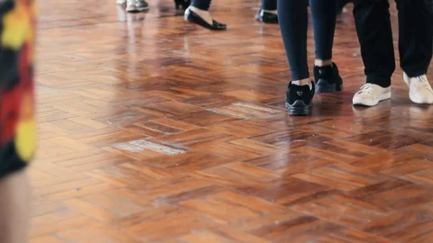 A tilt up of some legs dancing in a ballroon Stock Footage 86457575