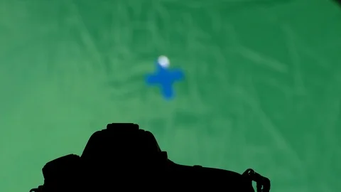 Tilt on spy dslr camera watch on green screen Stock Footage 87626764