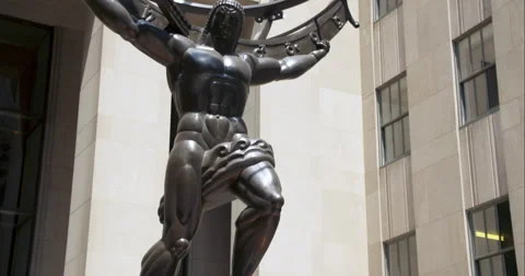 Tilt up on statue of man holding the world on shoulders Stock Footage 67257562