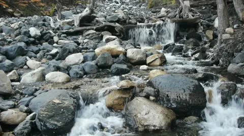 Tilt up from stream to glacial mountain Stock Footage 12474466