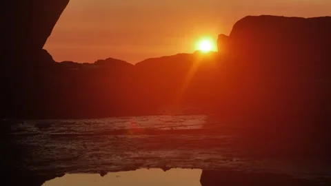 Tilt from sunrise rock reflection slow motion 4K Video stock 275501598