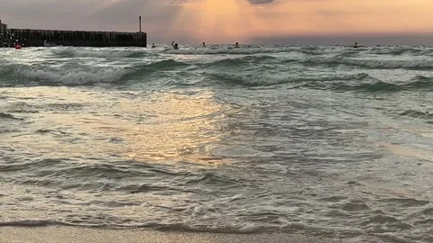 Tilt from sunset to golden waves sunset and sea Video stock 236349643