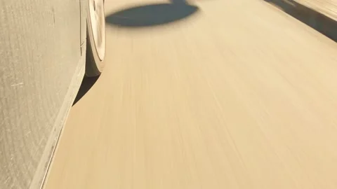 Tilt up top view fast motion car wheel spins fast in real time on asphalt roa Stockbeeldmateriaal 163809363