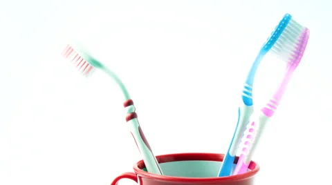 Tilt Up on Two Tooth Brushes in a Red Cup. Stock Footage 58942120