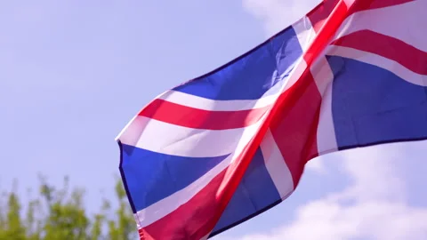 Tilt-up of Union Jack lightly fluttering with left side copy space Video stock 241973252