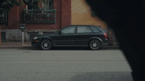 Tilt upwards between two yellow and maroon city buildings 스톡 동영상 91609437