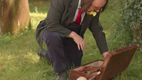 Tilt Up Of Vampire Hunter Packing Leather Suitcase With Wooden Tools Close Up Stock Footage 139788980