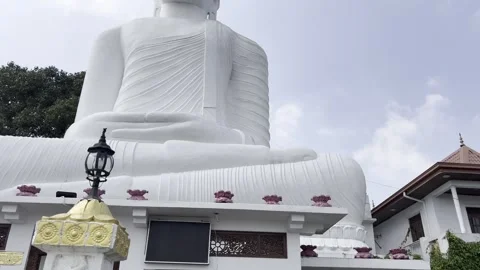 Tilt Up View of Buddha Statue at Sri Maha Bodhi Viharaya, Kandy Video stock 331527434