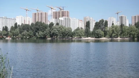 Tilt view on the construction of a residential complex near the river Stock-Footage 120022076