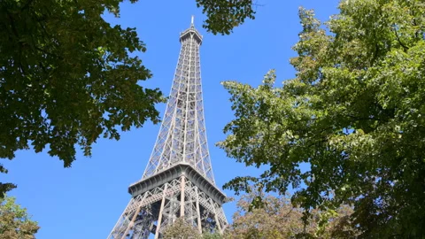 Tilt view of Eiffel Tower in Paris, France against blue sky Stock Footage 119544607