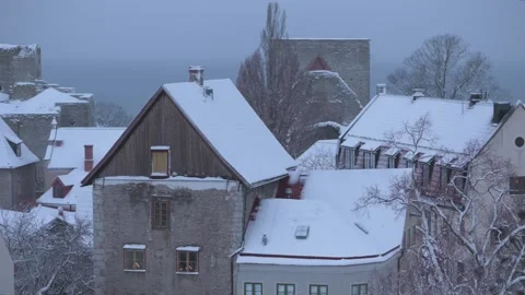 Tilt up view of snow-covered medieval houses in Visby, Gotland Stock Footage 328587336