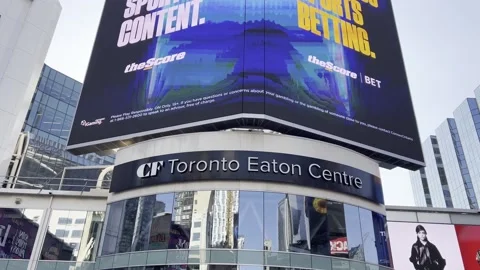 Tilt-up view of toronto eaton centre entrance and urban landscape Stock Footage 302581453
