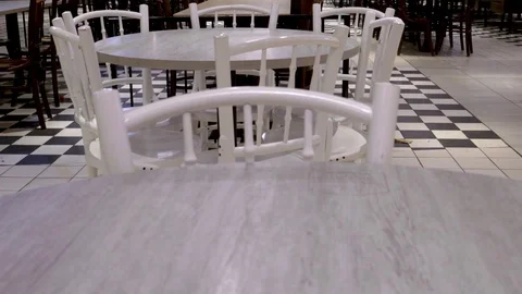 Tilt up view from white tables &amp; chairs, checked patterned flooring inside Stock Footage 108404419