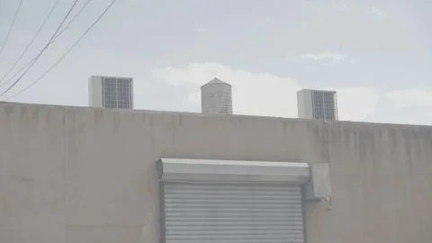 Tilt up Water tower and AC units on Warehouse Williamsburg BK 4K Stock Footage 250351430