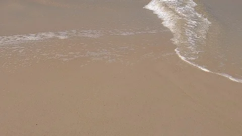 Tilt from the waves on the beach sand, up to the mountains of Rio de Janeiro Stock Footage 124181738