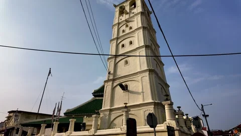 Tilted aerial angle highlights Kampung Kling Mosque multi tiered roof Stock Footage 332088927