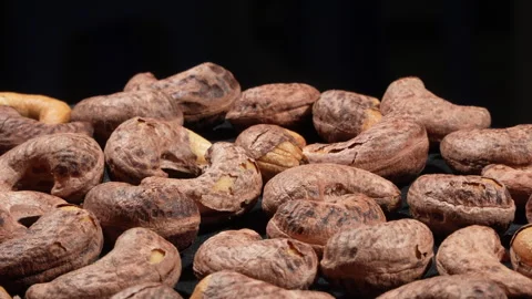 Tilted Angle of Salt-Roasted Cashew Nuts with Skin Rotating. Video stock 332840985