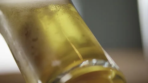 Tilted beer glass gets filled with beer Stock Footage 274628739