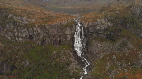 Tilted bird's eye view of waterfall and valley above Stock Footage 147031503