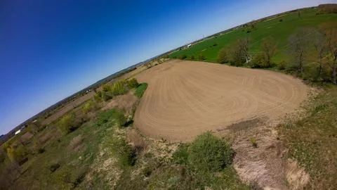 Tilted drone view of an empty tilled agricultural field Stock Photos