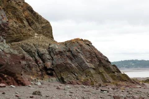 Tilted rock formations on a beach at low tide in the Bay of Fundy. Stock Photos