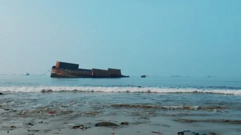 Tilted Stranded Cargo Barge Shipwreck Off the Coast Stock Footage 337803771