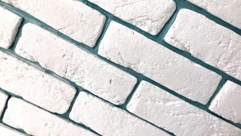 Tilted white brick wall video - textured pattern with green background Stock Footage 122819144