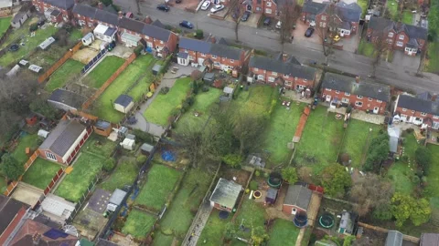 Tilting aerial generic view of a British housing estate of houses 動画素材 171528396