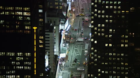Tilting up between skyscrapers to look at Times Square at night. Shot in 2011. Stock Footage 59172233