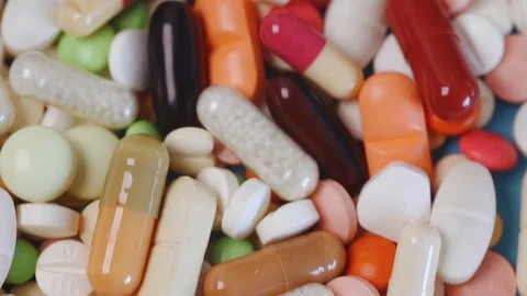 Tilting closeup view of stack of medication pills Stock Footage 95480225