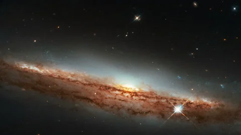 Tilting down at Glowing trail of red hot gases from a galaxy in outer space Stock Footage 154432938