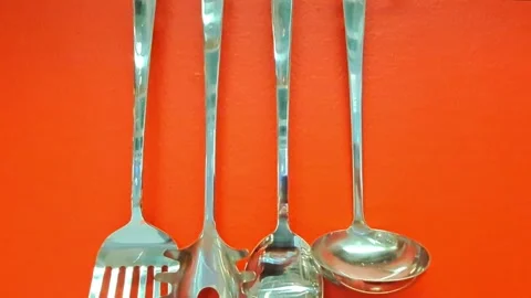 Tilting down on kitchen utensils on a red wall. 스톡 동영상 317166997
