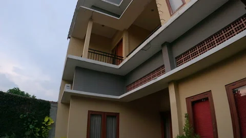 Tilting down reveal shot of backside modern house Stock Footage 200899701