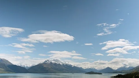 Tilting down from sky to alpine mountains and lake, Queenstown, New Zealand Stock Footage 89572805
