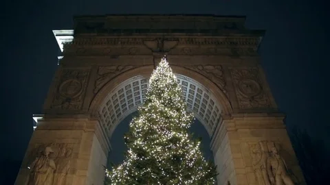 Tilting down from Washington Square Park arch Christmas tree lights night NYC Stock Footage 71166515