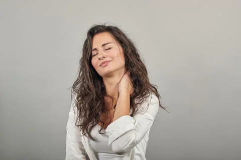 Tilting face side, gently touching neck with a hand, beauty redefined, looking Stock Photos