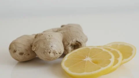 Tilting on lemon slices and ginger root close-up Stock Footage 86516335