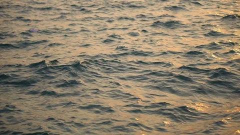 Tilting From Ocean Waves to Sun Setting Above Container Harbor With Cranes Stock Footage 126259359