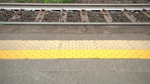 Tilting up from Platform to Train Tracks on a Train Station Video stock 158507716