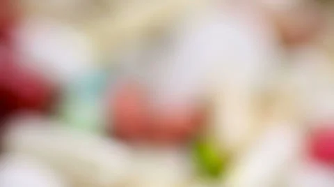 Tilting on red pill on heap of medication Stock Footage 24479641