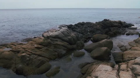 Tilting shot of cliffs, ocean and parasailing Video stock 50450610