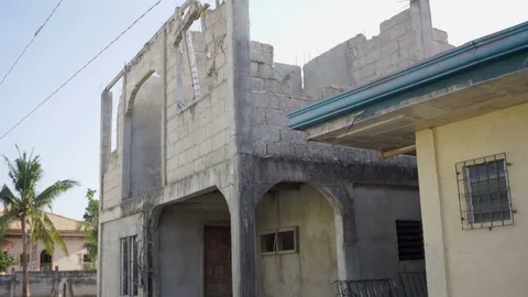 Tilting shot of a concrete building destroyed by a hurricane Stock Footage 76840218