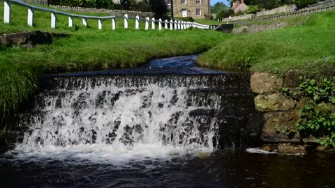 Tilting shot Hutton beck in Hutton le hole North Yorkshire Moors UK Stock Footage 148834560