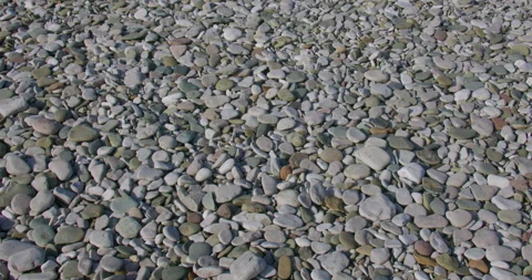 Tilting shot of Pebbles on the beach at pensarn, north Wales 動画素材 346191269