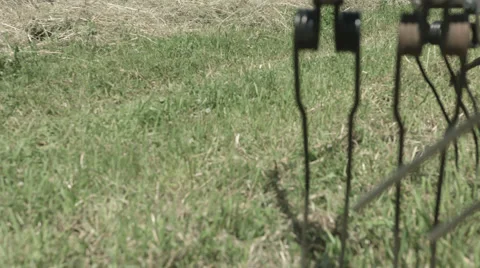 A tilting slider move on a Field while a Tractor is driving in the Background Stock Footage 66455676