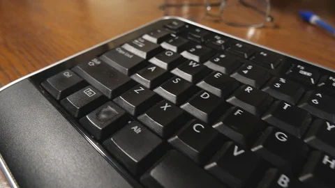 Tilting track across a computer keyboard Stock Footage 125055032